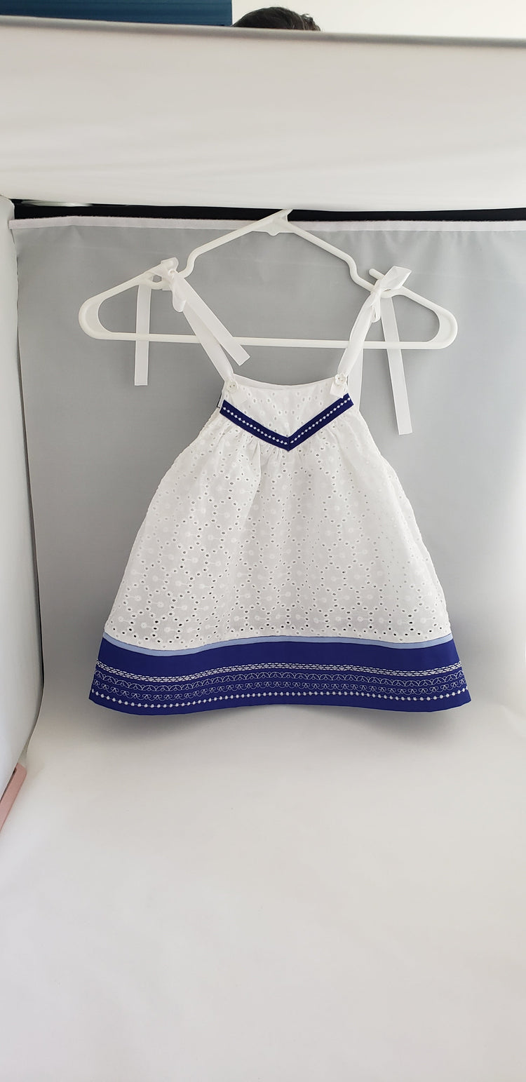 toddler dress in white eyelet fabric and custom made blue band.