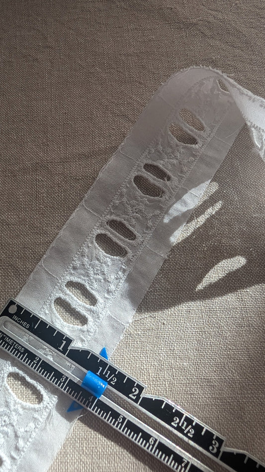 Close-up Martha Pullen Swiss Beading Trim flower motif with measuring gauge