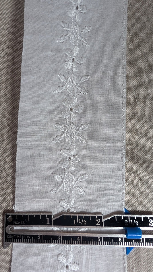 Swiss embroidery cotton trim from Martha Pullen in white with flower motif showing measuring gauge