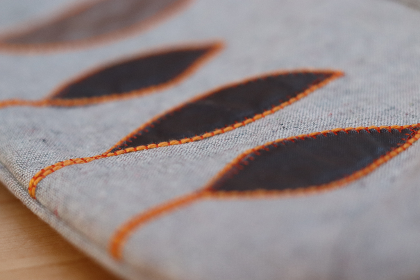 Detail also of appliqué on gray flap handbag clutch