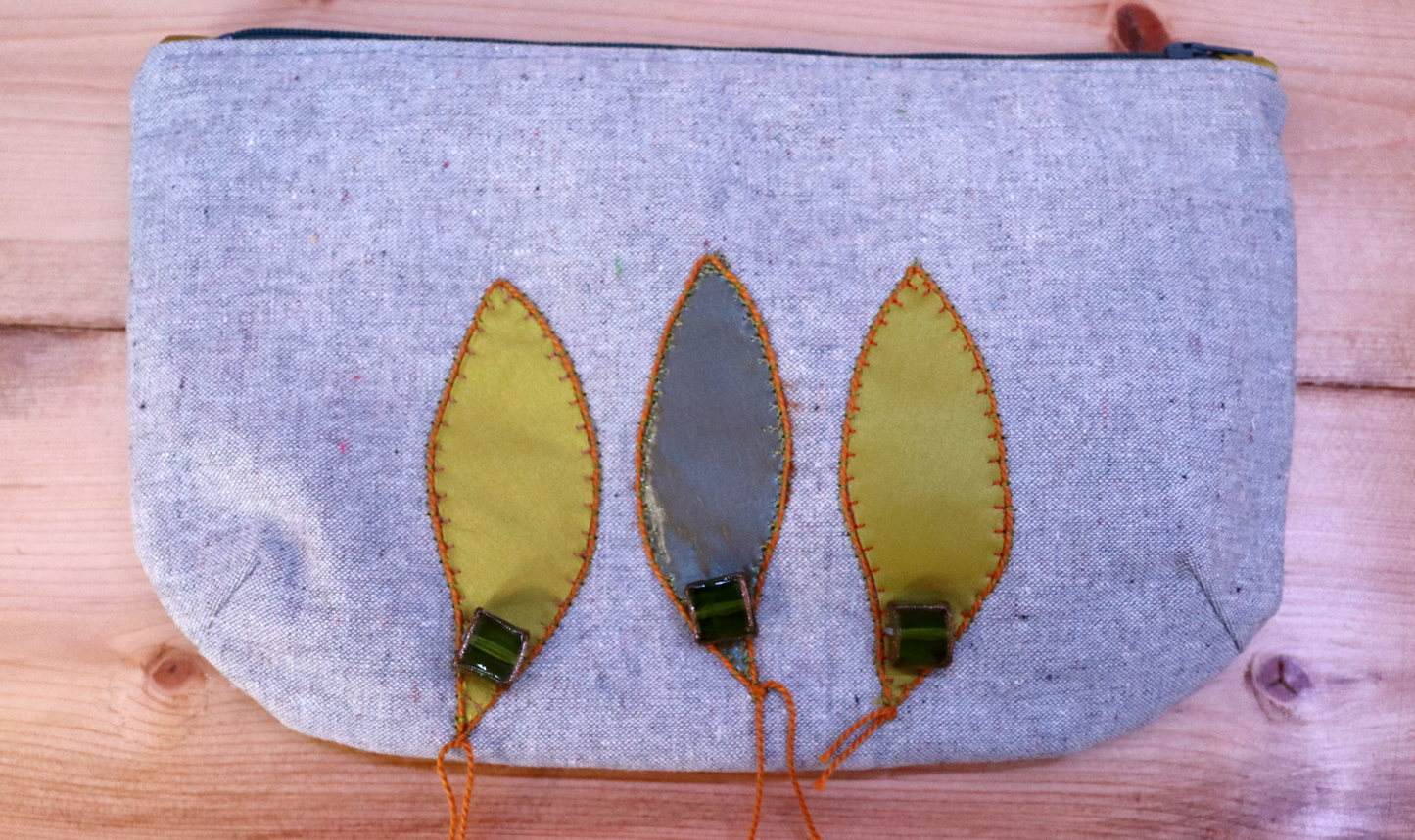 Gray and green handbag clutch with leaf appliqué