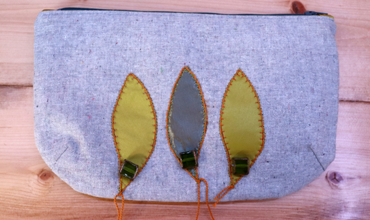Gray and green handbag clutch with leaf appliqué