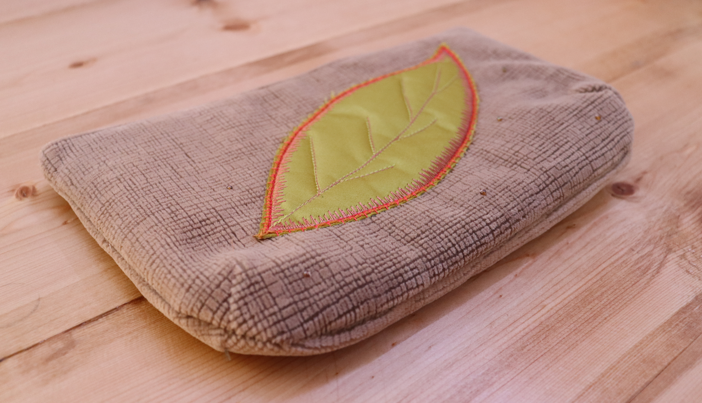 Side of blush pink and green appliqué leaf handbag clutch