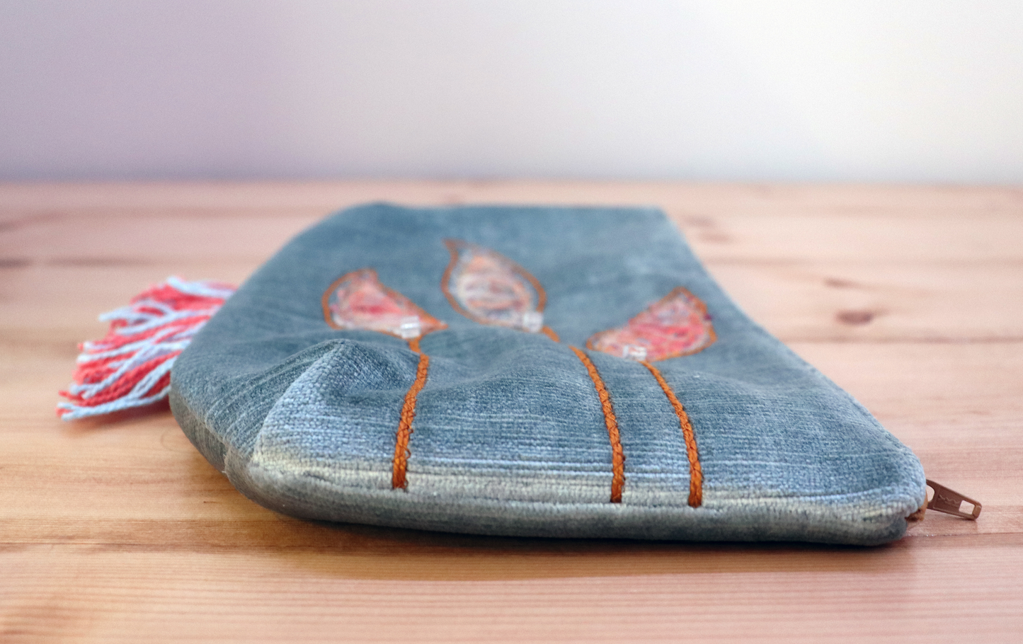 Detail of grayish blue fringe handbag clutch