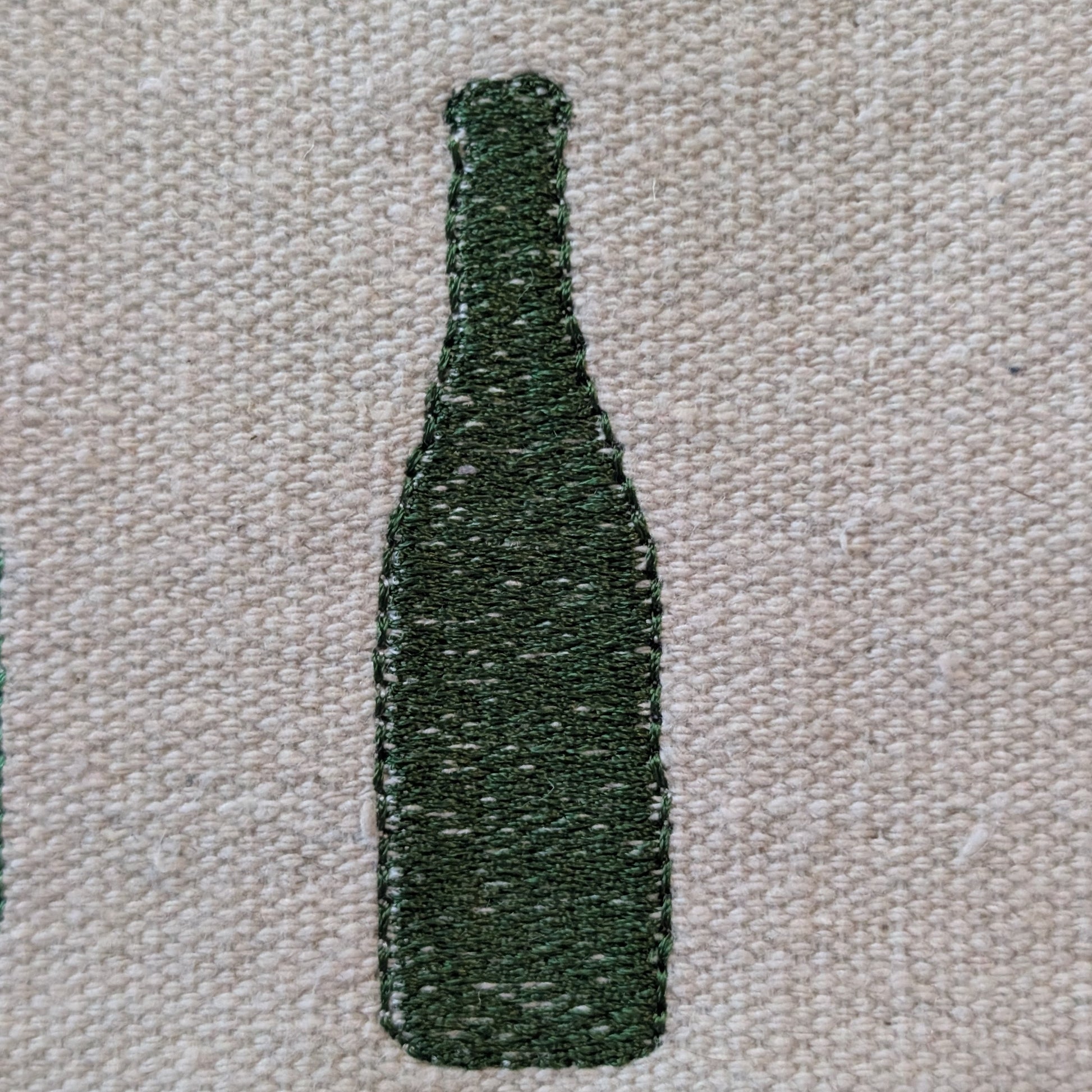 Dark green champagne bottle silhouette on a textured beige background