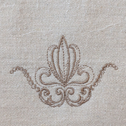 Decorative brown embroidery on beige fabric