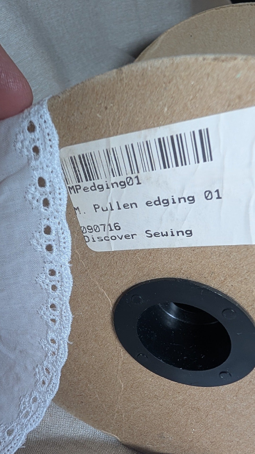 Close up of Martha Pullen swiss cotton trim with original product label attached to spool 