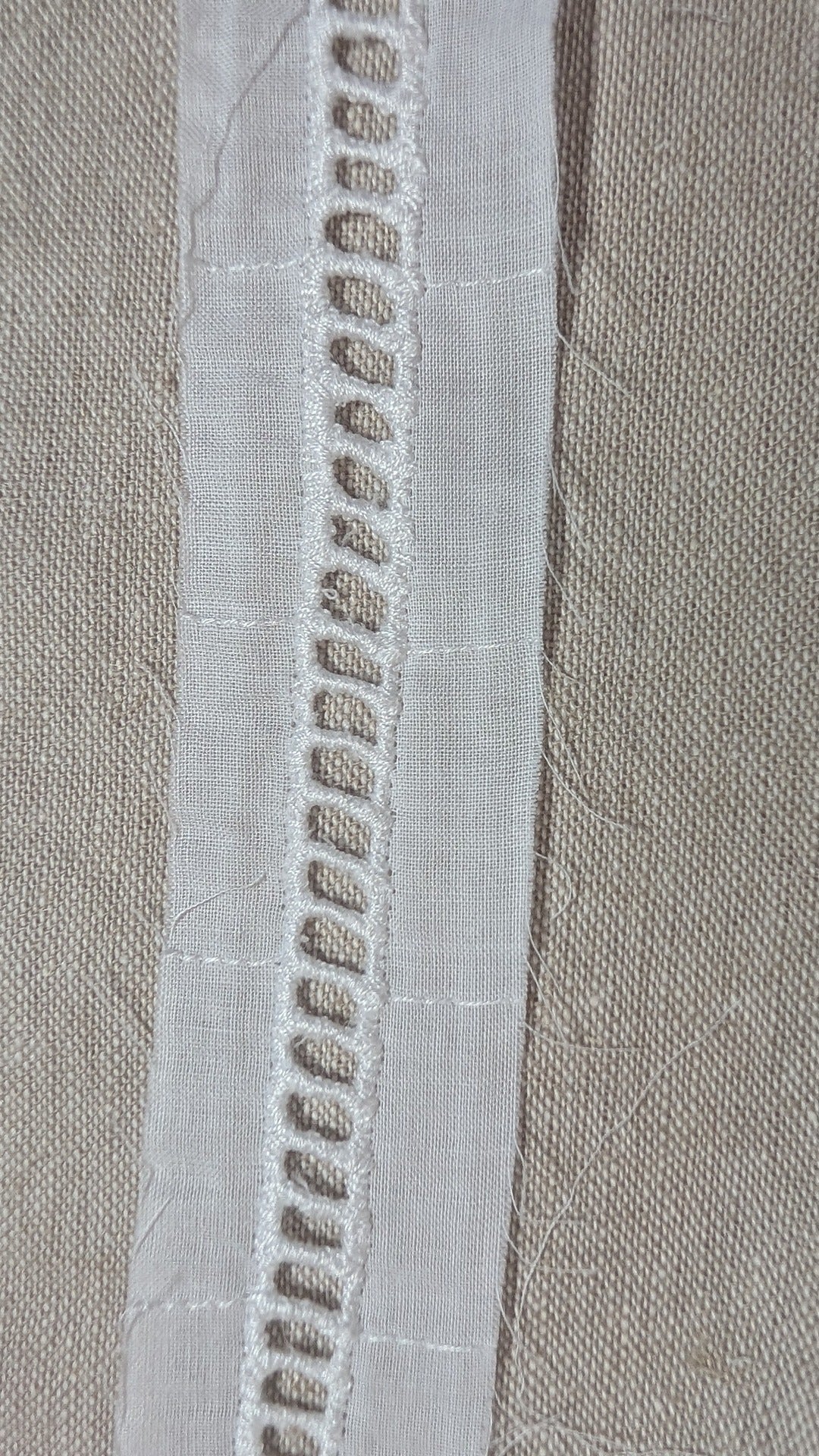 Close-up of ladder beading heirloom trim in white from Martha Pullen. Also called faggoting.