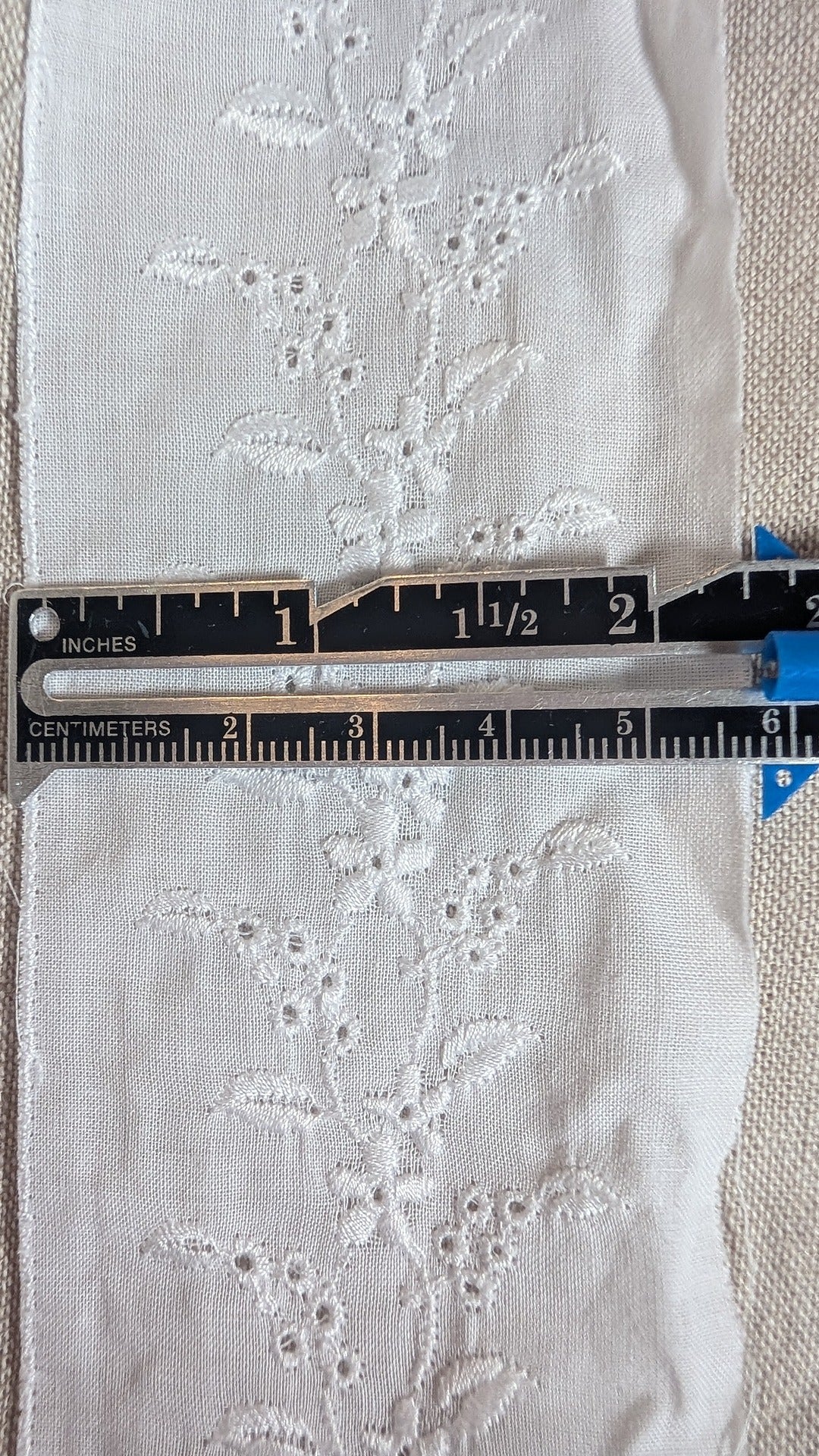 Close-up of Swiss embroidery cotton trim in white from Martha Pullen and measuring gauge