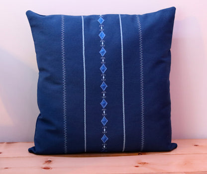 Blue square throw pillow cover with decorative trims.