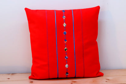 Orange square decorative throw pillow cover with decorative trims.