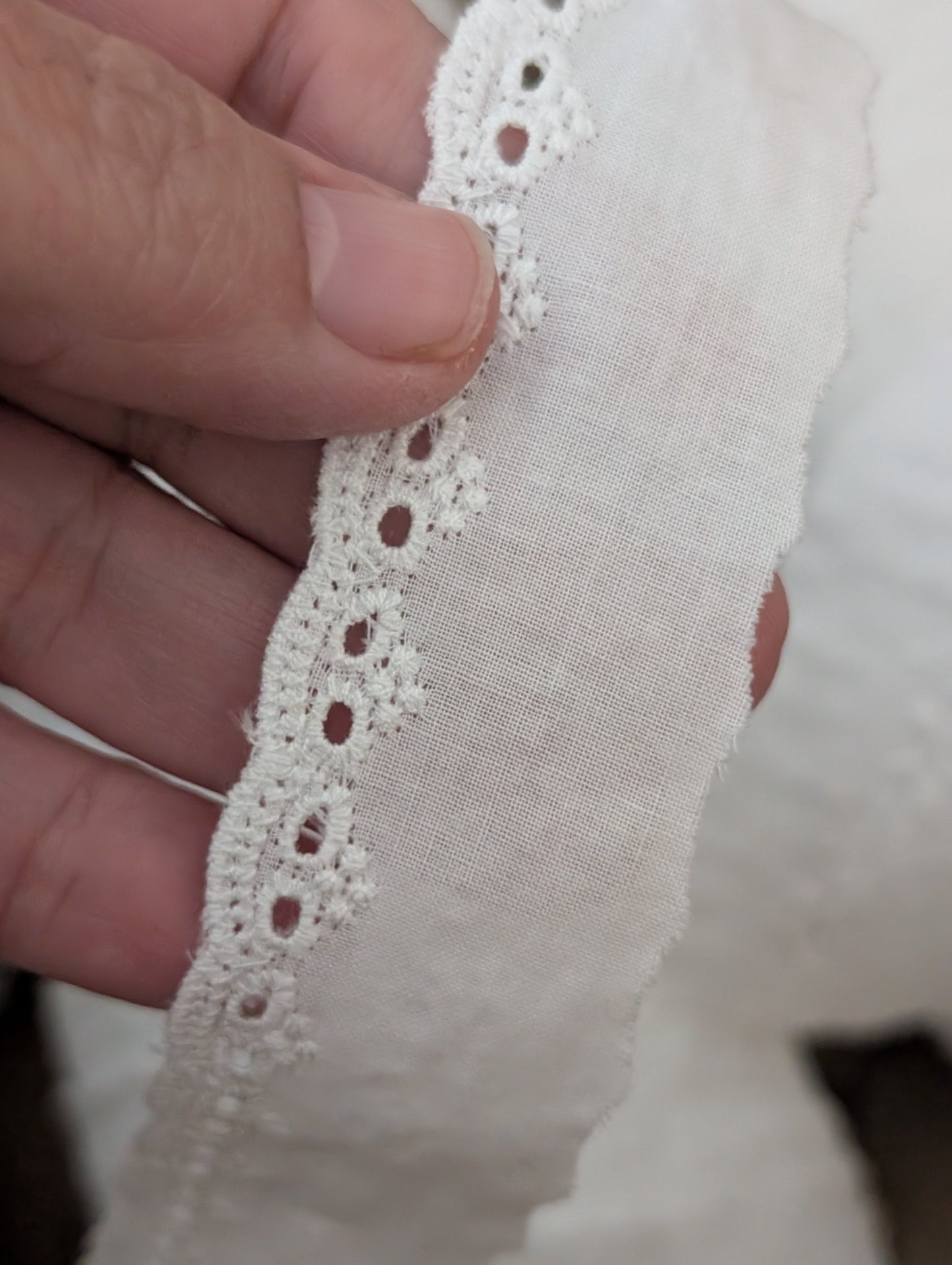 Close-up of white Martha Pullen Swiss cotton embroidery trim showing 3/8 inch delicate pattern for heirloom sewing