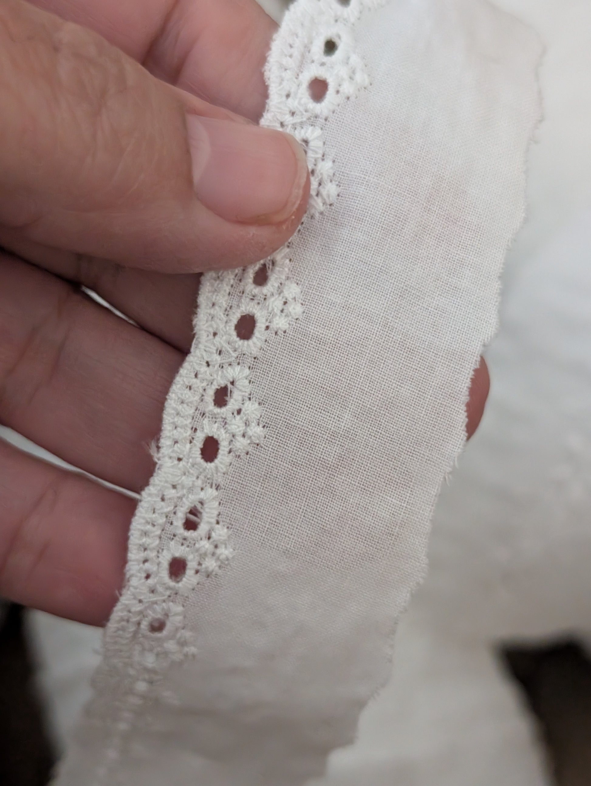 Close-up of white Martha Pullen Swiss cotton embroidery trim showing 3/8 inch delicate pattern for heirloom sewing
