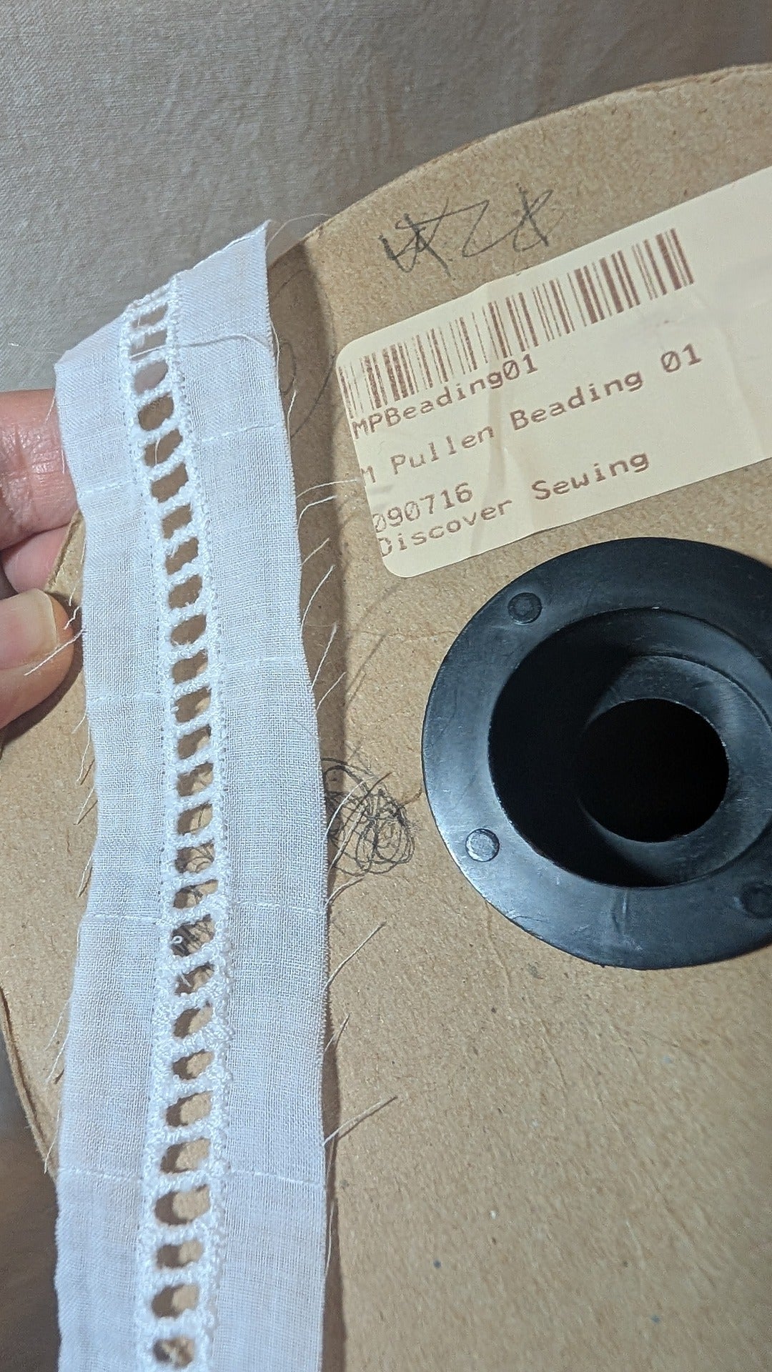 Close-up of beading ladder in cotton from Martha Pullen and product label