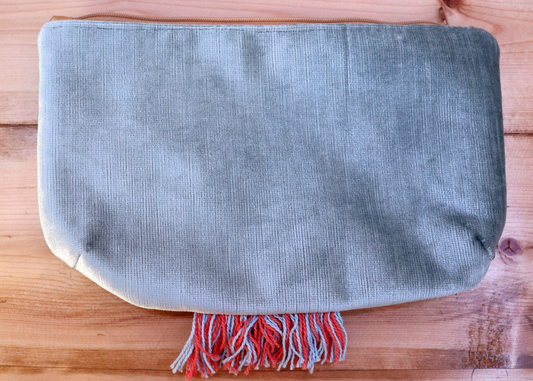 Back of grayish blue handbag clutch